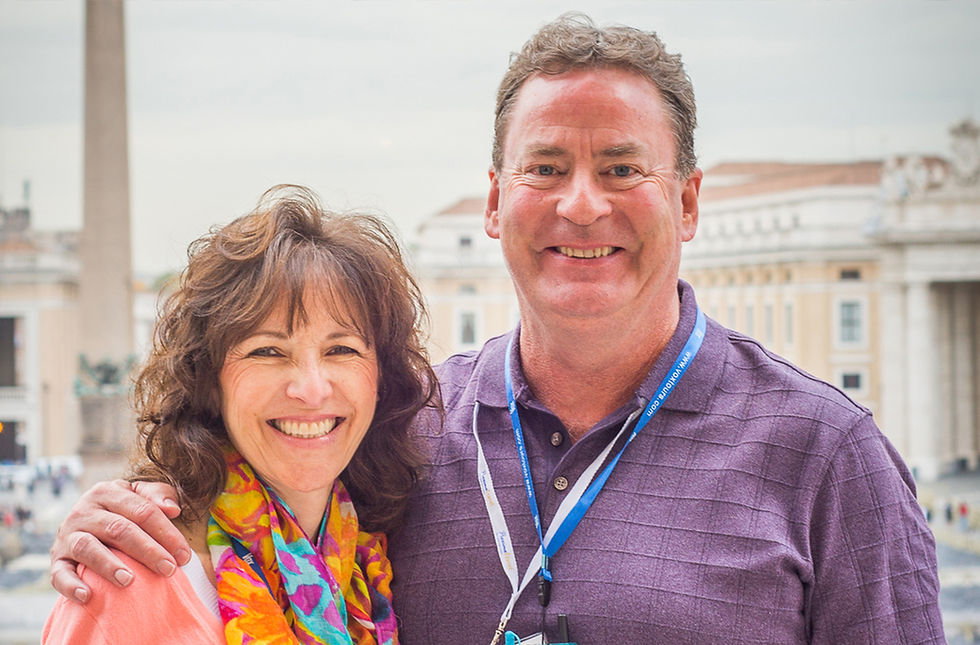 A middle aged couple smiling while touring a city